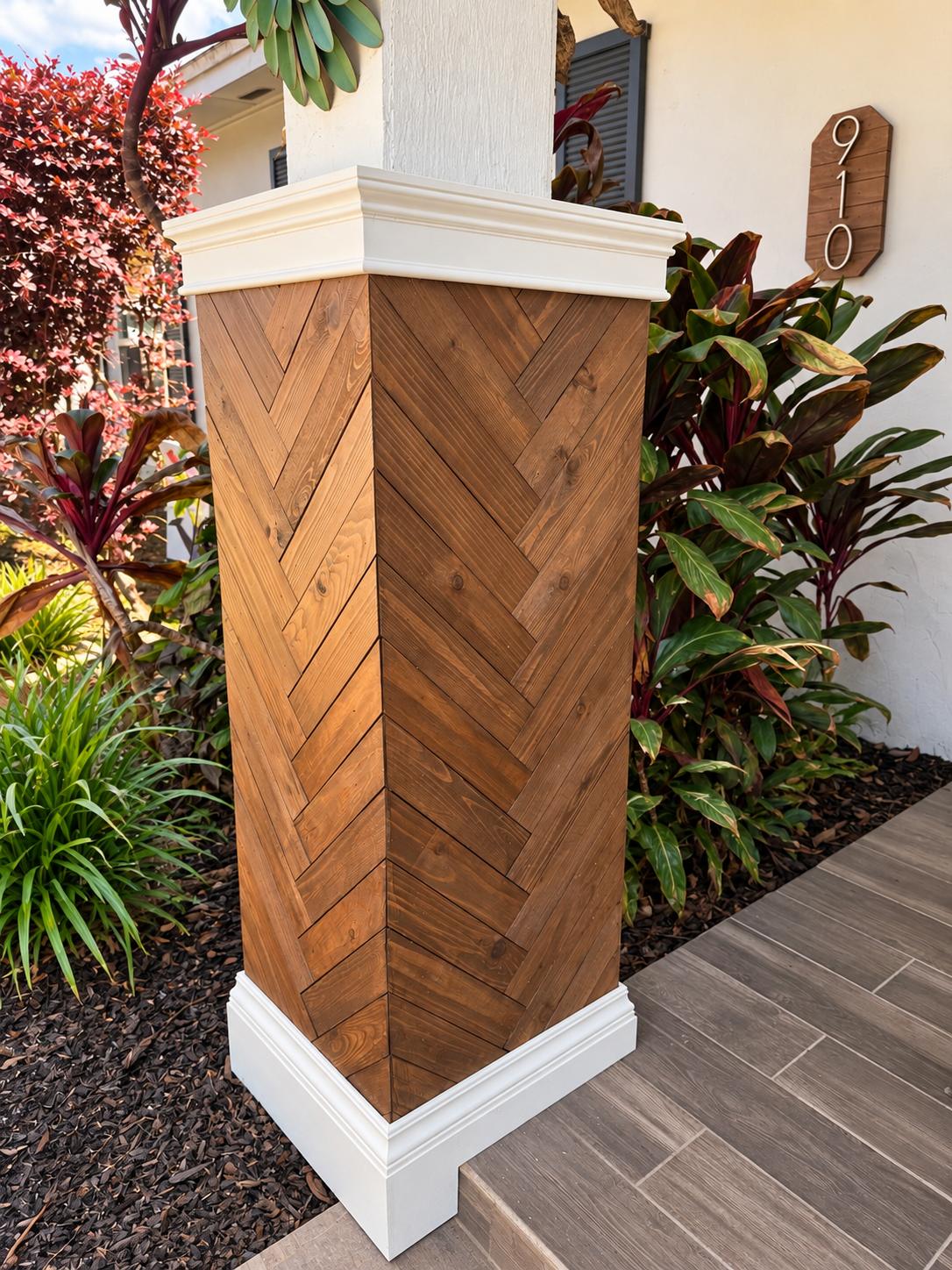 Porch column wrapped in herringbone wood with trim cap and base